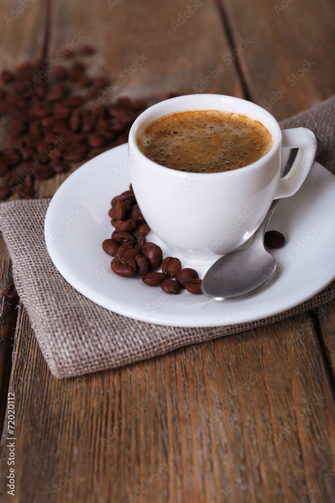 Cup of coffee with milk and coffee beans