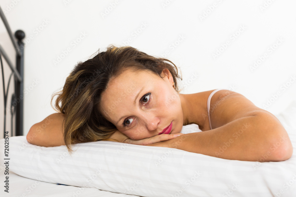 Fototapeta premium Upset woman laying in bed