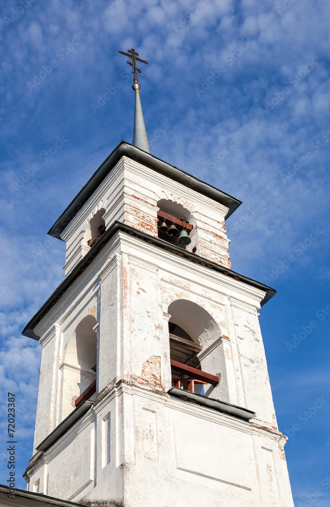 Bellfry of old Russian church against blue sky
