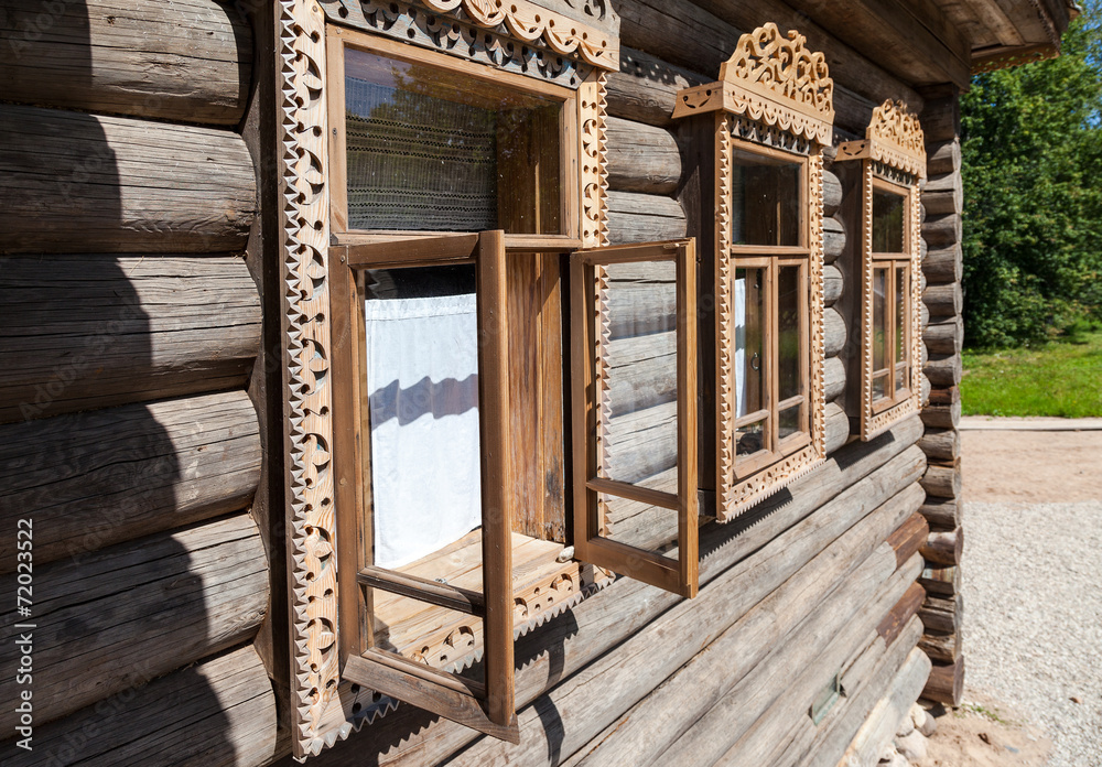 Windows on the facade of the old wooden house Windows on the facade of the old wooden house