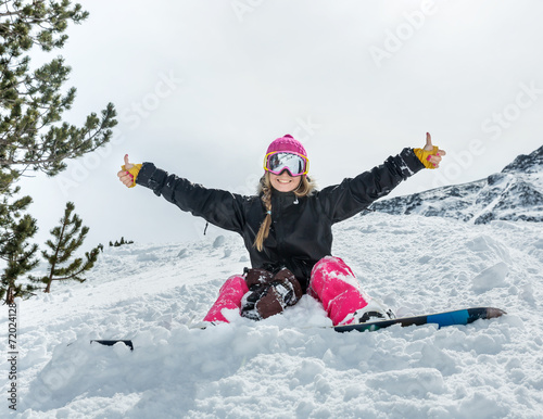 Joyful young woman snowboarder