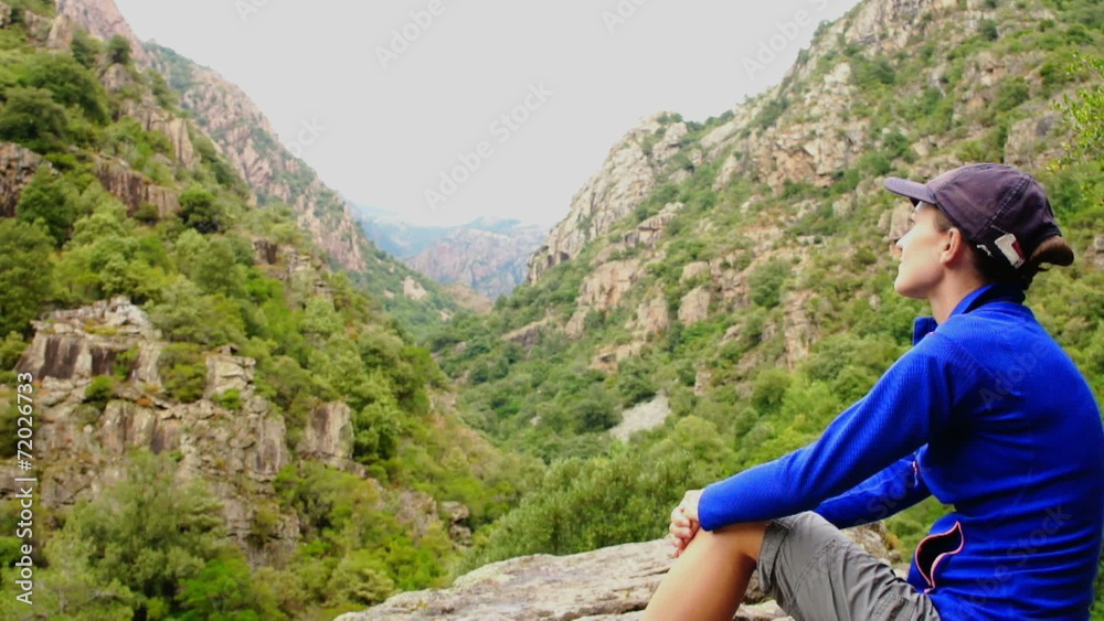 Female tourist enjoying beautiful view in the mountains Female tourist enjoying beautiful view in the mountains