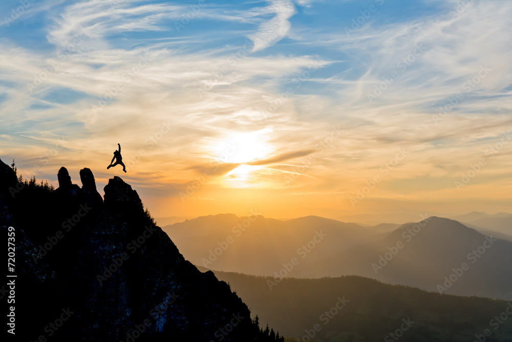 Naklejka premium hiker on the peak at sunset