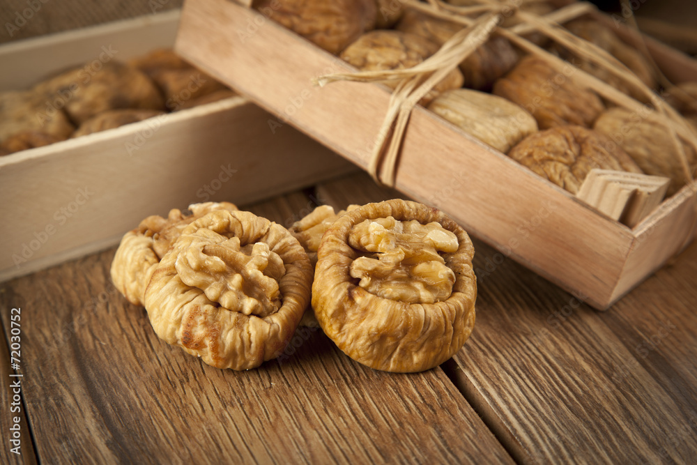 Dried figs with walnuts concept with wooden table Dried figs with walnuts concept with wooden table