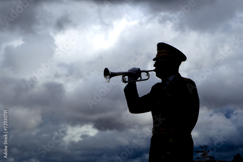 Silhouette of bugle player. photo