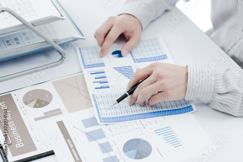 Businessman analyzing investment charts. Accounting