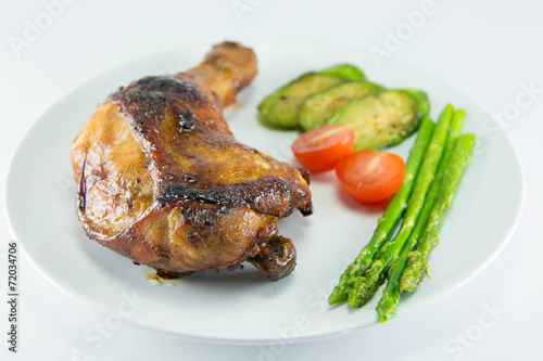 Closeup of roast chicken and vegetables
