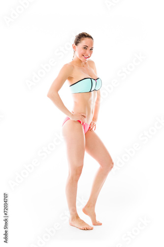 model isolated on plain background pround confident hands on hip