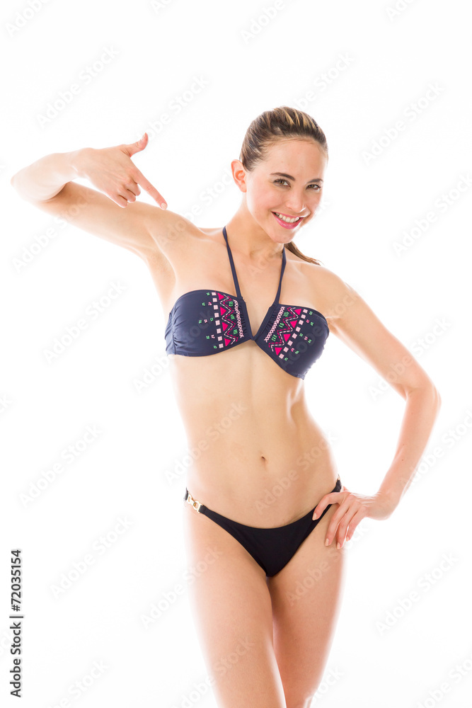 model isolated on plain background pointing to herself