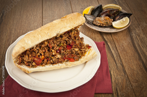 Turkish Kokorec - lamb intestine food sandwich with midye dolma photo