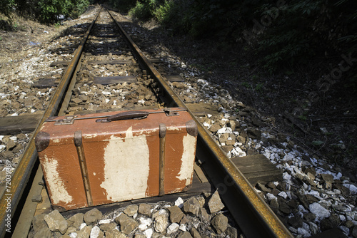 Vintage suitcase on railway road