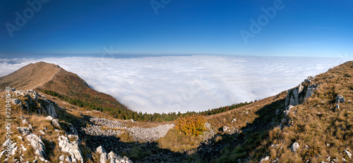 Above the clouds - mountain panorama photo