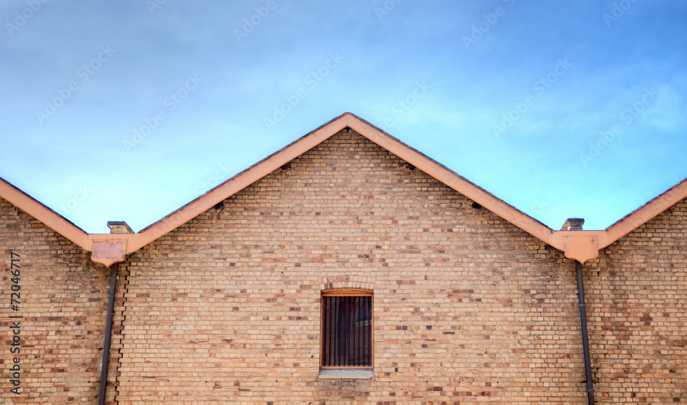 Old brick building with steel bars in window Old brick building with steel bars in window