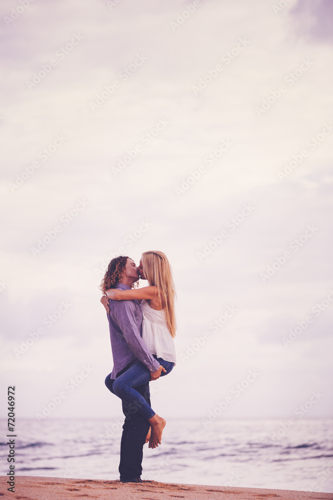 Young Couple Kissing on the Sea Shore Young Couple Kissing on the Sea Shore