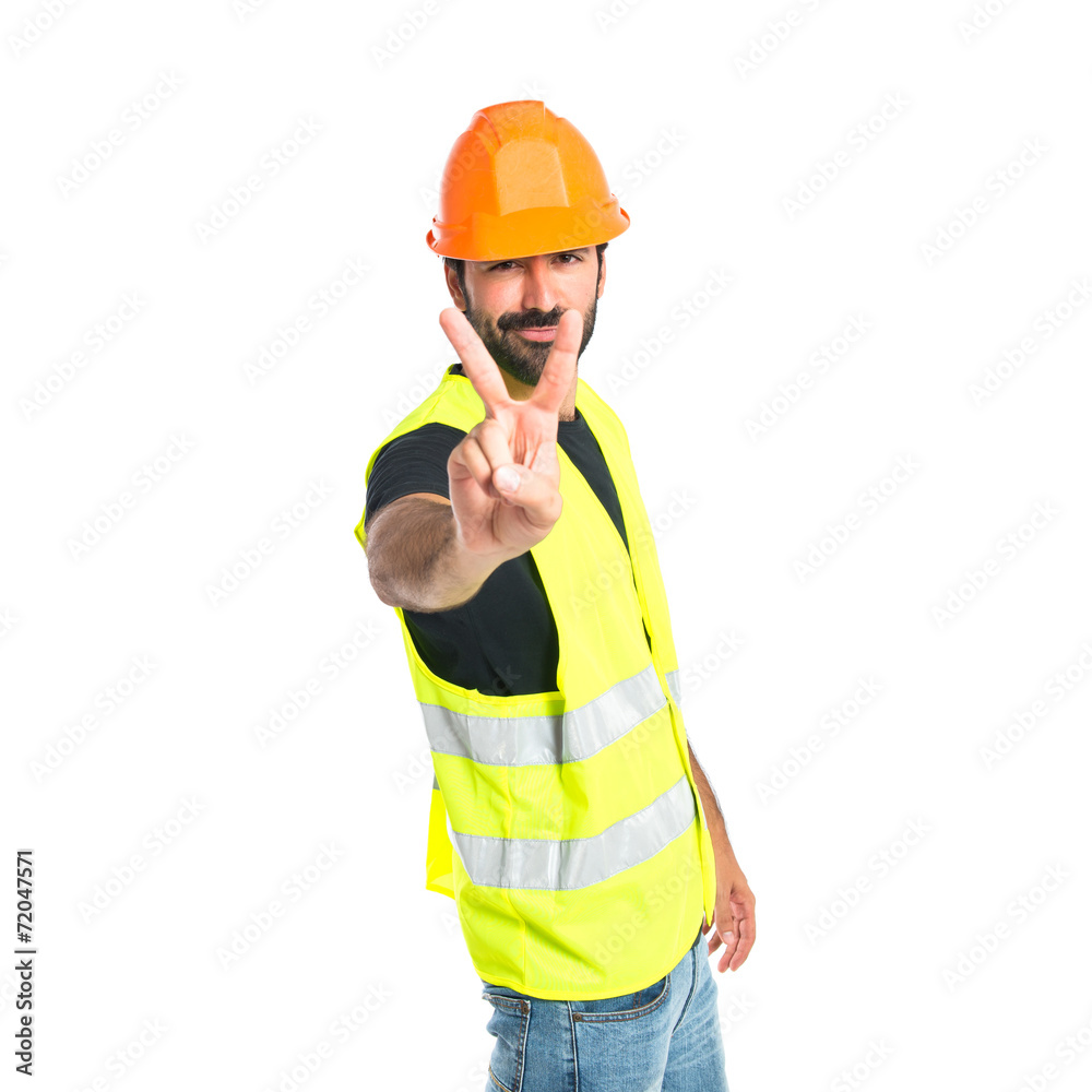 Workman doing victory gesture over white background Workman doing victory gesture over white background
