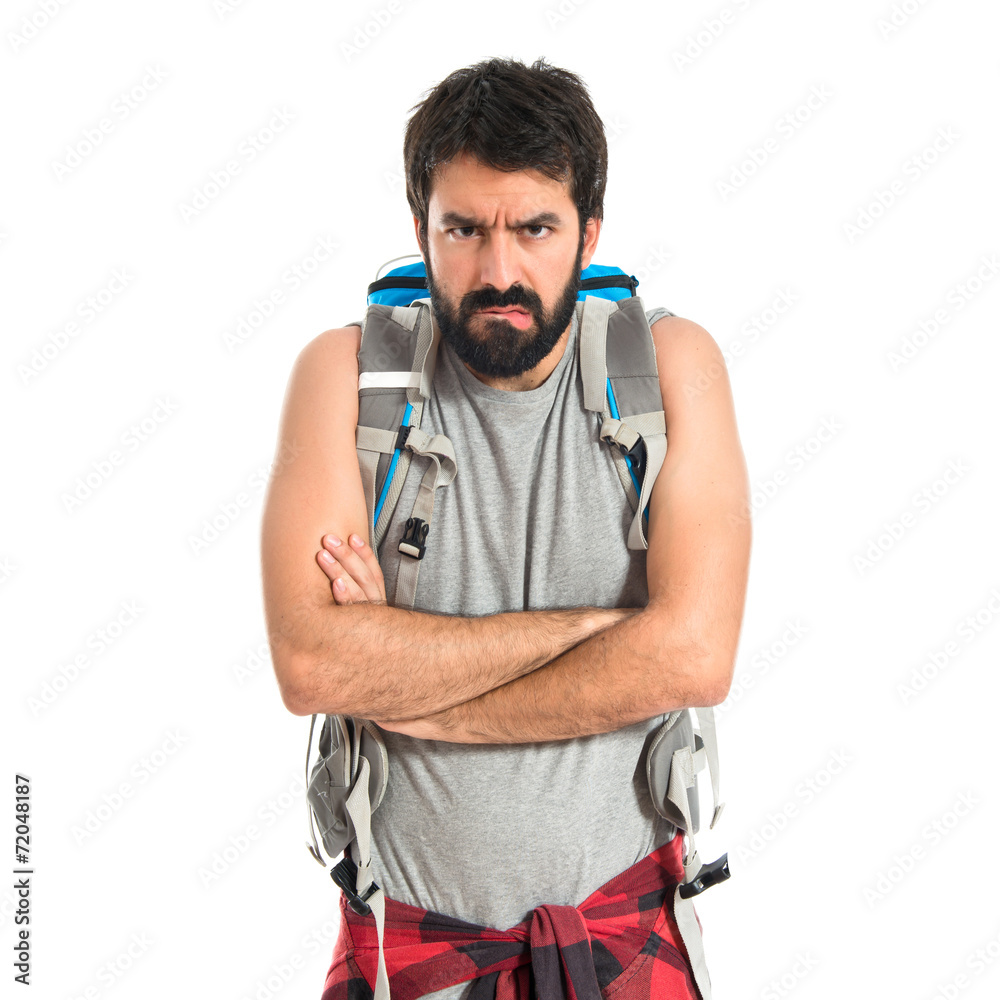 Angry backpacker over isolated white background Angry backpacker over isolated white background