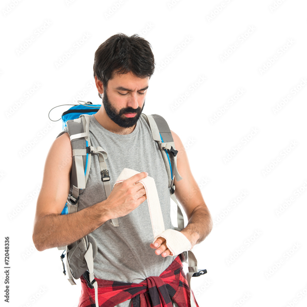 Backpacker healing a wounded over white background Backpacker healing a wounded over white background