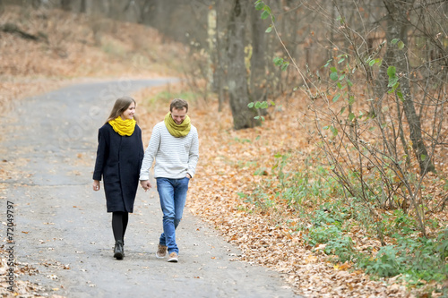 The girl and the guy walk on the autumn wood © Irina84