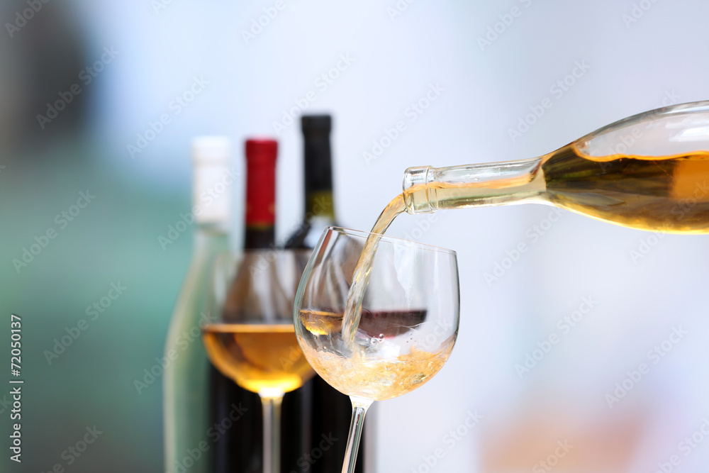 Wine pouring into wine glass, close-up Wine pouring into wine glass, close-up