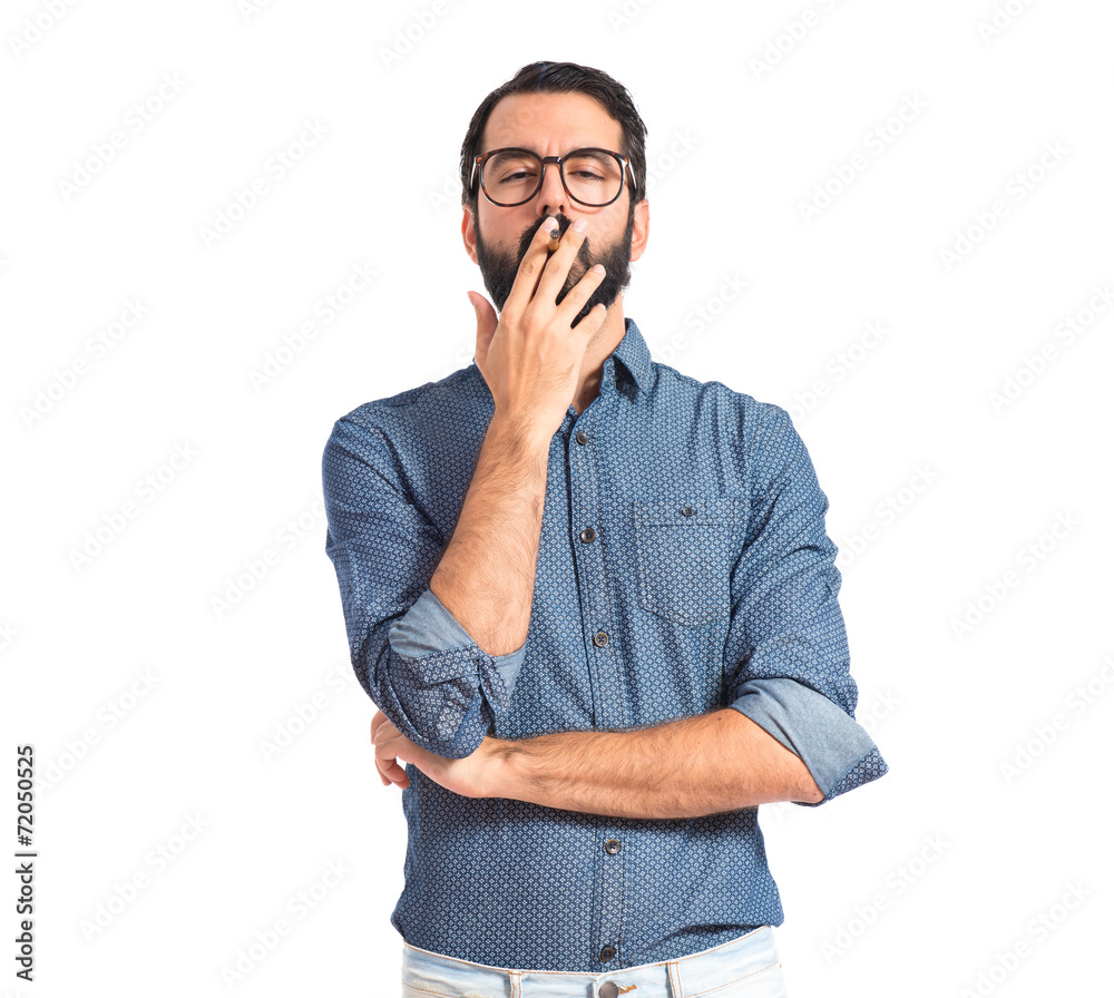 Young hipster man smoking over white background Young hipster man smoking over white background