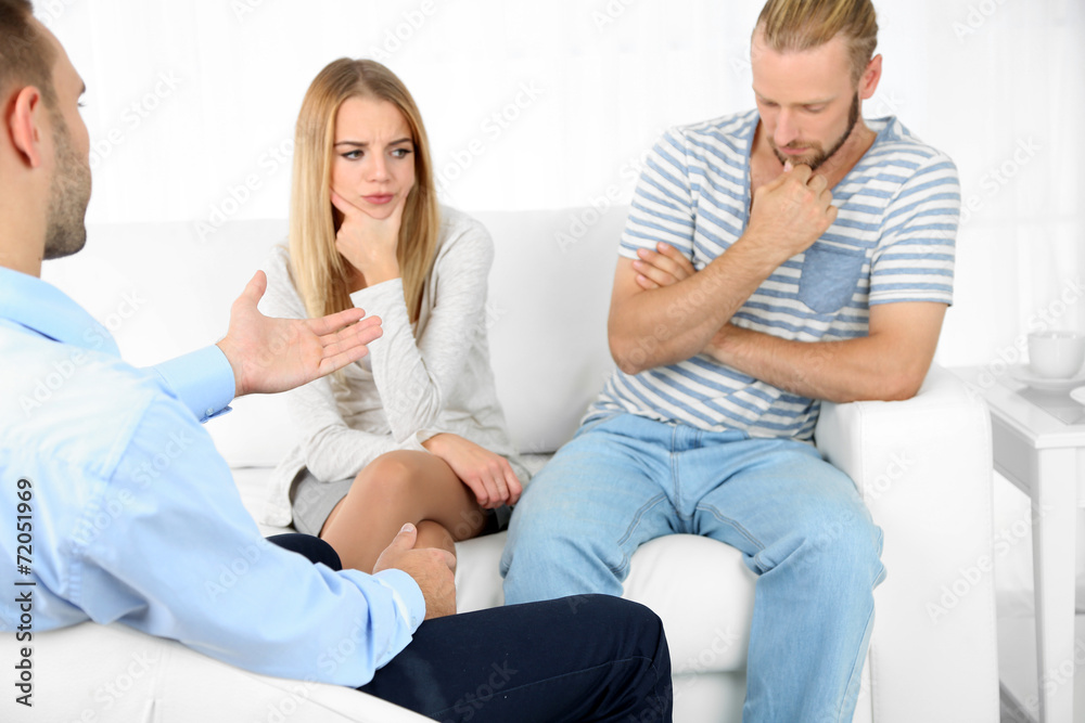 Unhappy couple not talking on couch at therapy session Unhappy couple not talking on couch at therapy session
