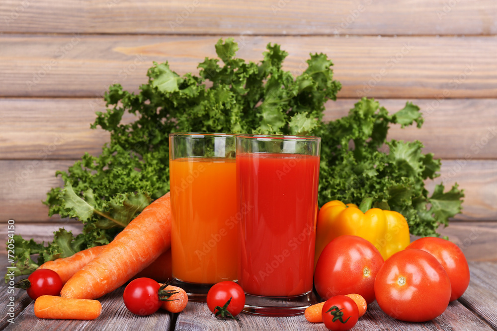Carrot and tomato juice in glasses and fresh vegetables Carrot and tomato juice in glasses and fresh vegetables