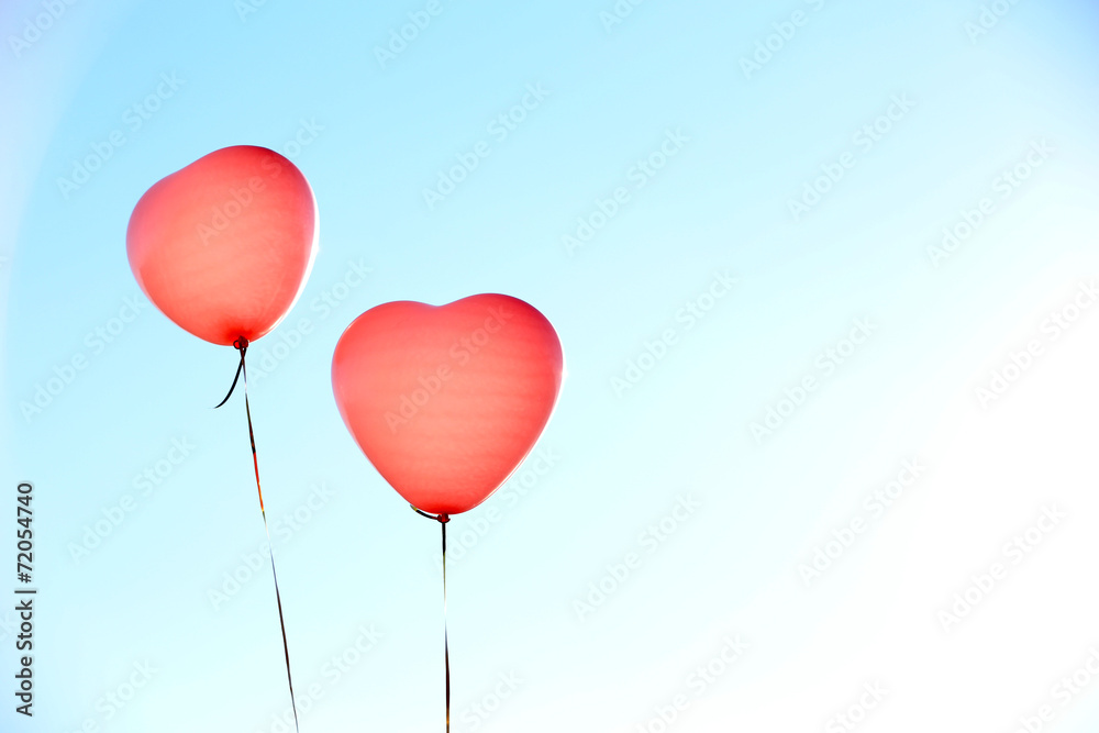 Love heart balloons on sky background
