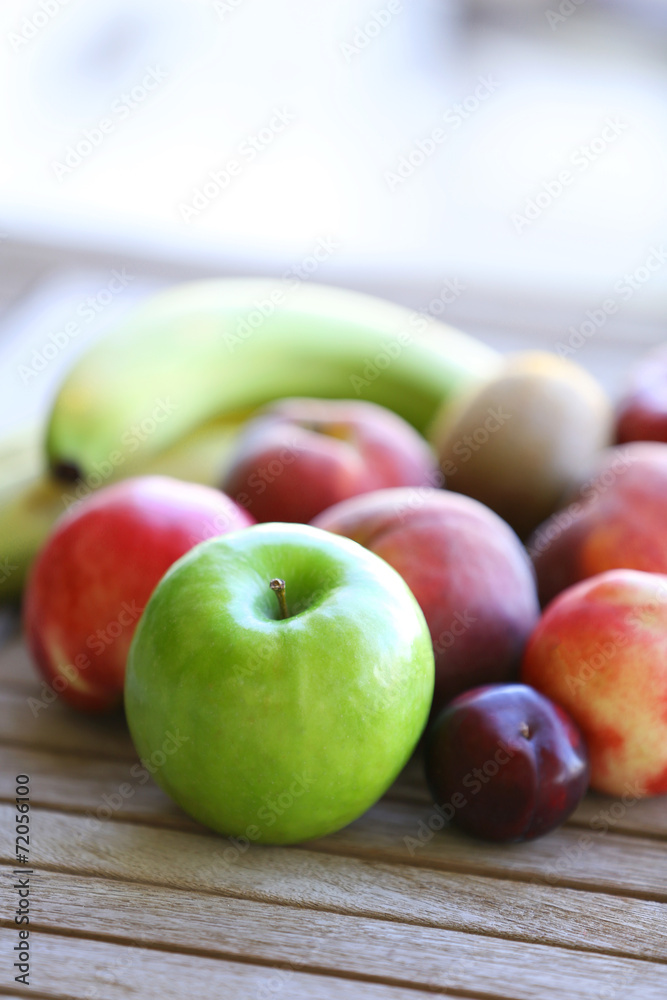 Juicy fruits on wooden table, close-up Juicy fruits on wooden table, close-up