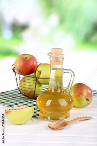 Fototapeta Naklejka Na Ścianę i Meble -  Apple cider vinegar in glass bottle and ripe fresh apples,