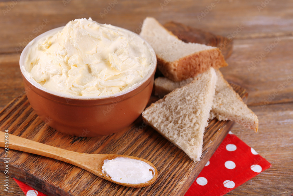 Fresh homemade butter in bowl and sliced bread, Fresh homemade butter in bowl and sliced bread,