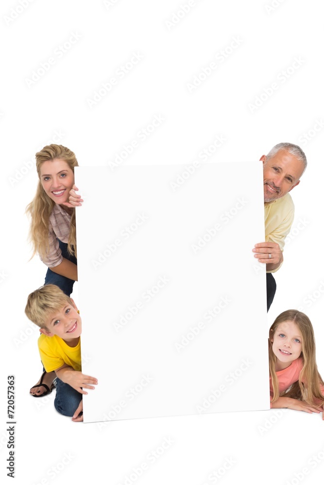 Happy family showing white card Happy family showing white card