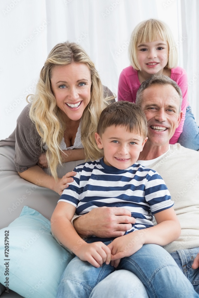 Portrait of a smiling family sitting on sofa Portrait of a smiling family sitting on sofa