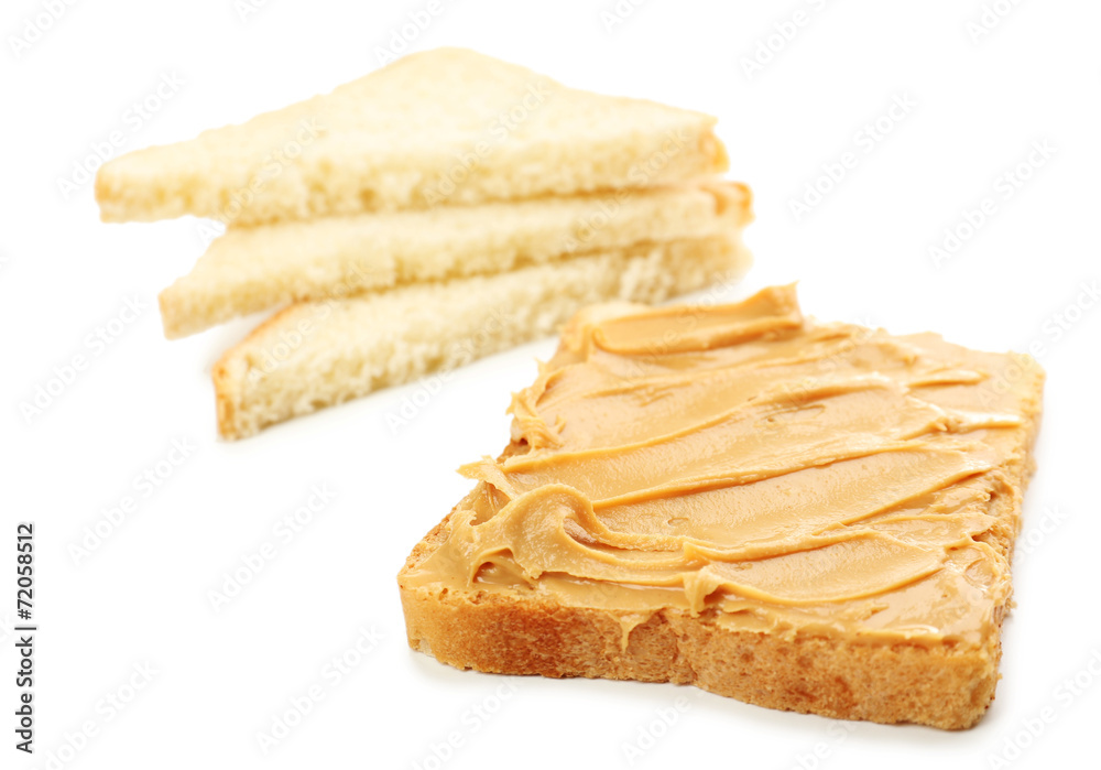 Creamy peanut butter and bread slices, isolated on white Creamy peanut butter and bread slices, isolated on white