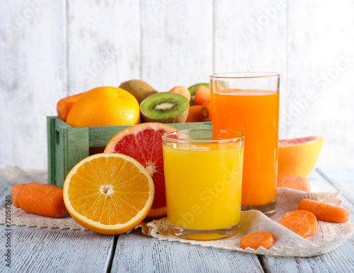 Fruit and vegetable juice in glasses and fresh fruits in box