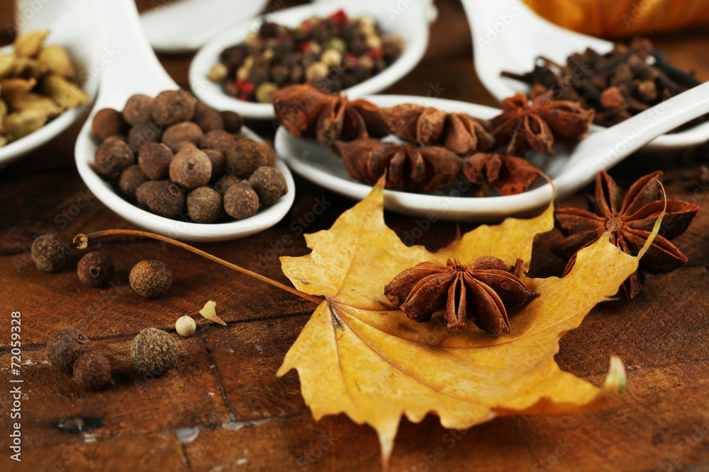 Different spices in spoons with yellow leaves Different spices in spoons with yellow leaves