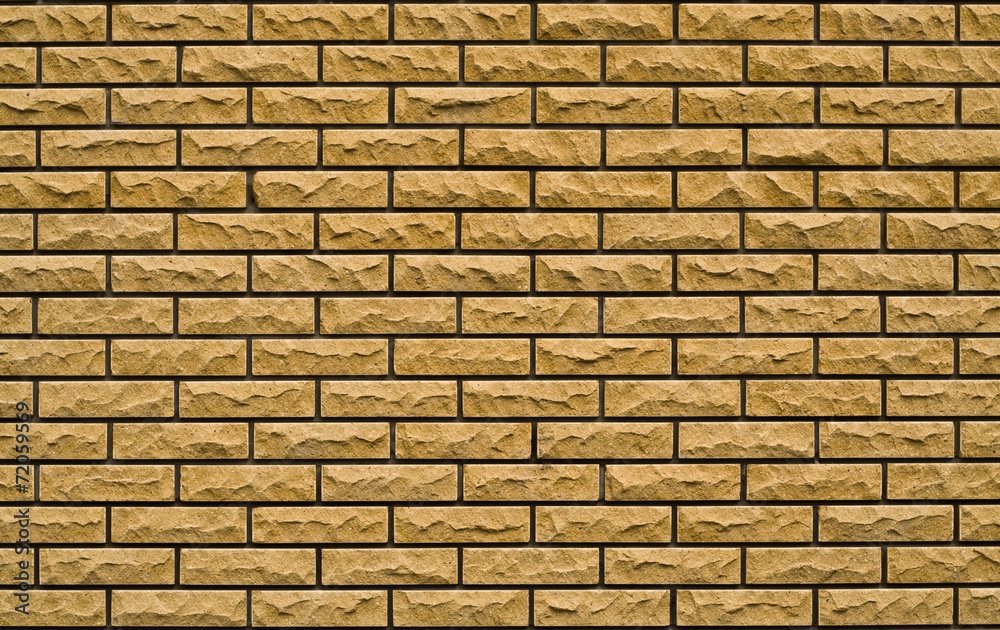 Obraz premium even yellow, rough brick wall