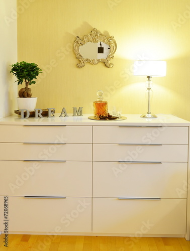 Chest drawer in the interior of a stylish bedroom