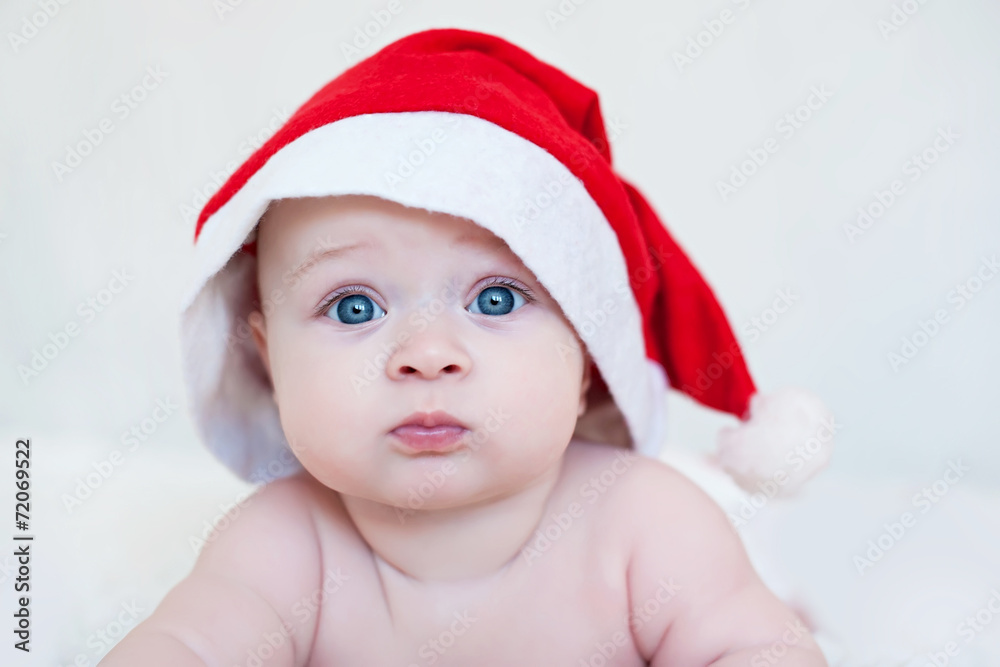 child wearing red Christmas cap, isolated over white child wearing red Christmas cap, isolated over white