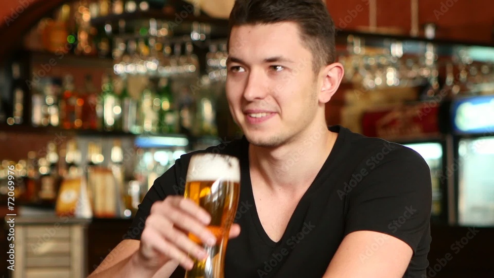 Guy watching sports at bar and rejoicing Guy watching sports at bar and rejoicing