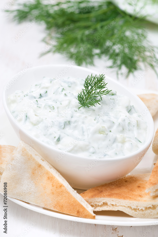 yoghurt sauce tzatziki with pieces of pita bread, vertical yoghurt sauce tzatziki with pieces of pita bread, vertical