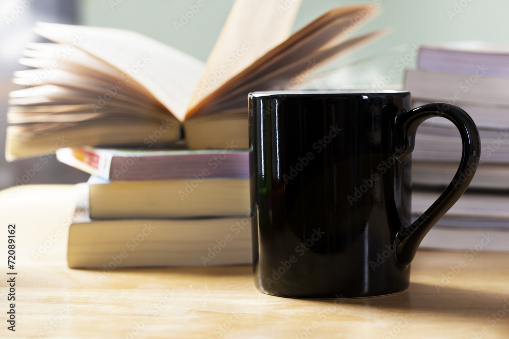 Fototapeta premium black coffee cup and book pile
