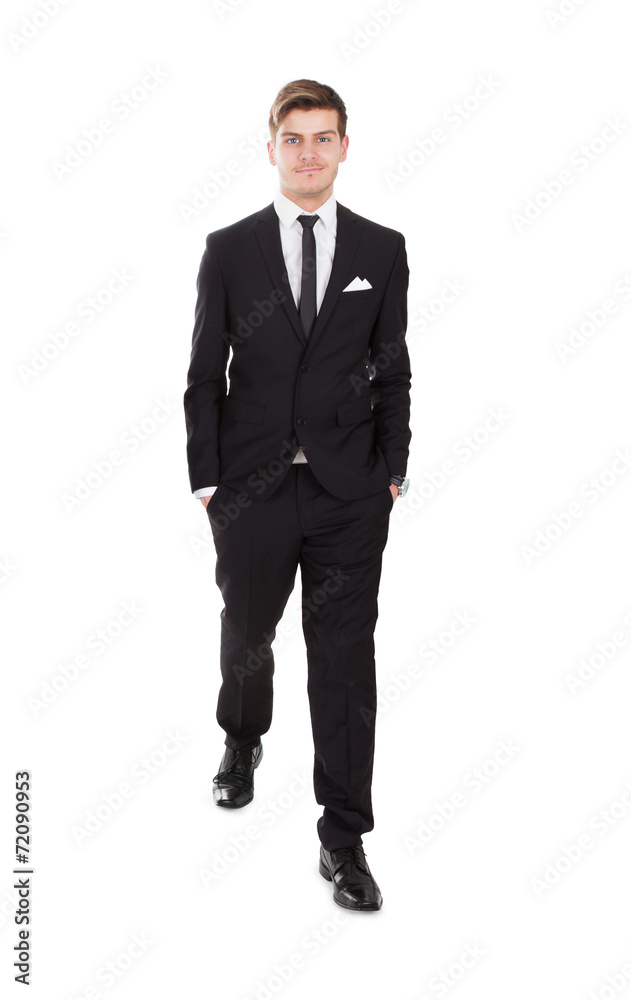 Smiling Businessman Walking Over White Background Smiling Businessman Walking Over White Background