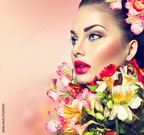 High fashion model girl with colorful flowers and red lips