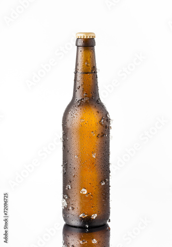 Bottle of ice cold beer with ice and drops