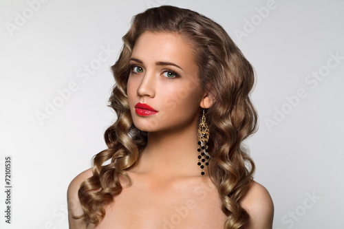 Portrait of beautiful girl with blond curly hair