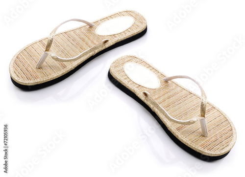 Gold flip flops on a white backgrond