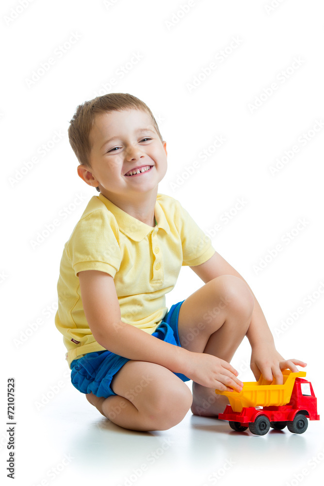 funny kid playing with lorry toy isolated on white funny kid playing with lorry toy isolated on white