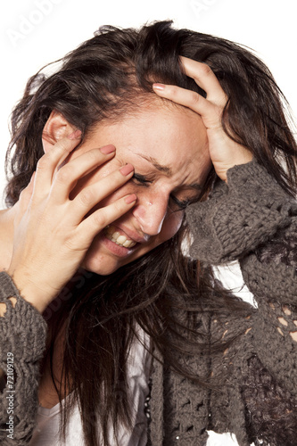 Depressive messy and crying woman on white background
