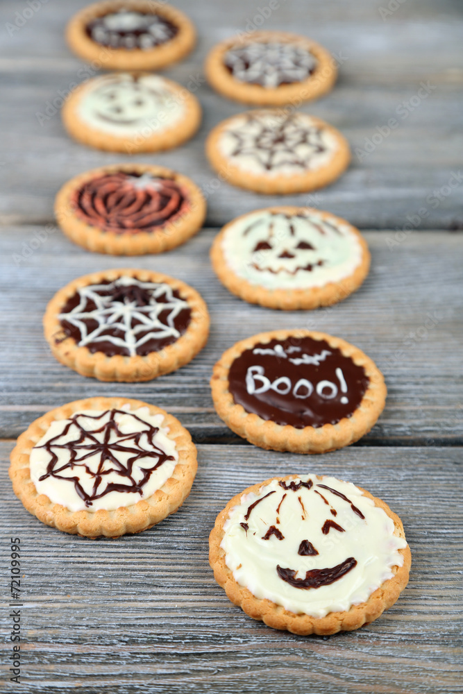 Tasty Halloween cookies on wooden table