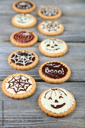Tasty Halloween cookies on wooden table